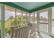 Inviting screened porch with views of the surrounding tropical trees at 6 4Th Ave, Isle of Palms, SC 29451