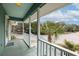 Inviting porch with scenic views of the street and palm trees, enhanced by a beautiful sunny sky at 6 4Th Ave, Isle of Palms, SC 29451