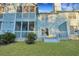 Exterior view of home, features a screened porch, a well-maintained lawn, and a backyard deck at 6275 Rolling Fork Rd # C, North Charleston, SC 29406