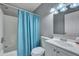 Well-lit bathroom features a blue shower curtain and a vanity with ample storage space at 6275 Rolling Fork Rd # C, North Charleston, SC 29406