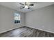 Bright bedroom featuring a ceiling fan, neutral walls, and a window with a view at 6275 Rolling Fork Rd # C, North Charleston, SC 29406