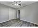 Cozy bedroom with gray walls, wood-look floors, and a ceiling fan at 6275 Rolling Fork Rd # C, North Charleston, SC 29406