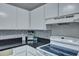 Traditional kitchen with white cabinetry, stylish backsplash, and modern appliances at 6275 Rolling Fork Rd # C, North Charleston, SC 29406