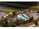 Aerial view of a community pool with lounge chairs and a playground with some trees surrounding the area at 641 Sienna Way, Summerville, SC 29486