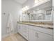 Bright bathroom with a double sink vanity, granite countertops, and a large mirror at 641 Sienna Way, Summerville, SC 29486