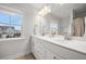 Clean, modern bathroom with double vanity sinks and a large window offering neighborhood views at 641 Sienna Way, Summerville, SC 29486