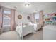 Charming bedroom with two twin beds, soft pink curtains, and a bookshelf at 641 Sienna Way, Summerville, SC 29486