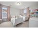Charming bedroom with two twin beds, soft pink curtains, and a bookshelf at 641 Sienna Way, Summerville, SC 29486