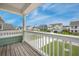 View from covered back deck overlooking a manicured lawn and neighboring homes at 641 Sienna Way, Summerville, SC 29486