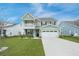 Charming two-story home boasts a spacious front yard, two car garage, and a quaint second story balcony at 641 Sienna Way, Summerville, SC 29486