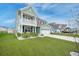 Inviting two-story home showcasing a well-manicured lawn, green exterior, and a convenient two-car garage at 641 Sienna Way, Summerville, SC 29486