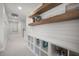 Hallway with built-in cubbies, wood shelves, and white shiplap walls create an organized and stylish space at 641 Sienna Way, Summerville, SC 29486