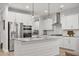 Bright kitchen featuring a granite island with pendant lights, stainless steel appliances, and white cabinetry at 641 Sienna Way, Summerville, SC 29486