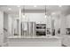 Modern kitchen with stainless steel appliances, white cabinets, island and granite countertops at 641 Sienna Way, Summerville, SC 29486