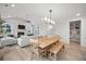 Open-concept living and dining area with fireplace, large windows and modern furniture at 641 Sienna Way, Summerville, SC 29486
