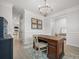 Bright office space with crown molding, decorative wainscoting, light wood floors, and an elegant wooden desk at 641 Sienna Way, Summerville, SC 29486