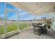 Screened-in patio with decorative string lights, a dining table and chairs, and an expansive backyard at 641 Sienna Way, Summerville, SC 29486
