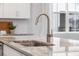 Close up of kitchen sink with granite countertops, faucet and white cabinets at 641 Sienna Way, Summerville, SC 29486