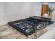 Close up of cooktop with burners and stainless steel knobs set on marble countertops at 641 Sienna Way, Summerville, SC 29486