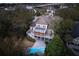 Stunning aerial view of the home with a pool, a spacious deck, and lush greenery at 7 Seahorse Ct, Isle of Palms, SC 29451