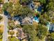 An aerial view of several upscale homes with manicured lawns and private pools nestled amongst mature trees at 7 Seahorse Ct, Isle of Palms, SC 29451