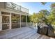 A spacious back deck features an open-air dining space, a screened-in lounge, and a black BBQ grill at 7 Seahorse Ct, Isle of Palms, SC 29451