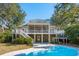 Backyard with a large pool, covered patio, second story screened porch and top deck at 7 Seahorse Ct, Isle of Palms, SC 29451