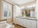 Bathroom with double vanity, granite countertops, and a soaking tub offers luxury and comfort at 7 Seahorse Ct, Isle of Palms, SC 29451