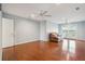Bright bonus room featuring hardwood floors, ceiling fans, and a cozy sofa for relaxing at 7 Seahorse Ct, Isle of Palms, SC 29451