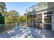 Outdoor deck boasts a screened-in porch with an above-ground pool and trees in the background at 7 Seahorse Ct, Isle of Palms, SC 29451