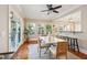 Bright dining area with patio access, many windows and seamless transition to kitchen at 7 Seahorse Ct, Isle of Palms, SC 29451