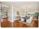 Elegant dining room with hardwood floors, a stylish table with seating for six, and an adjacent open living space at 7 Seahorse Ct, Isle of Palms, SC 29451