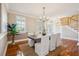 Well-lit dining area with stylish furnishings, hardwood floors, and easy access to the front door and staircase at 7 Seahorse Ct, Isle of Palms, SC 29451