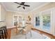 Cozy dining room featuring French doors to deck, wood floors, and views of outdoor greenery at 7 Seahorse Ct, Isle of Palms, SC 29451