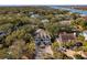 Stunning aerial view of a home with a welcoming front porch surrounded by mature trees and landscaping at 7 Seahorse Ct, Isle of Palms, SC 29451