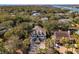 Stunning aerial view of a home with a welcoming front porch surrounded by mature trees and landscaping at 7 Seahorse Ct, Isle of Palms, SC 29451