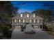 Charming two-story home featuring a double porch, three dormer windows, and a spacious driveway at 7 Seahorse Ct, Isle of Palms, SC 29451