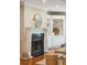 Stylish fireplace with white mantel, round mirror, and built-in cabinets with shelving at 7 Seahorse Ct, Isle of Palms, SC 29451