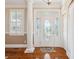 Bright entryway with a white front door featuring an oval glass window, complemented by a decorative rug and trim at 7 Seahorse Ct, Isle of Palms, SC 29451