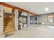 Large garage area with block walls, concrete floors, wooden stairs, and overhead beams at 7 Seahorse Ct, Isle of Palms, SC 29451