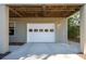 A ground-level two car garage door with a white paneled garage door at 7 Seahorse Ct, Isle of Palms, SC 29451