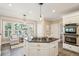 Bright kitchen with a gas cooktop island, white cabinets, stainless appliances and a breakfast nook at 7 Seahorse Ct, Isle of Palms, SC 29451