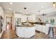 Well-equipped kitchen with ample white cabinetry, granite countertops, and an island gas cooktop at 7 Seahorse Ct, Isle of Palms, SC 29451