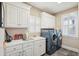 Bright laundry room with washer, dryer, sink, and ample counter space for added convenience at 7 Seahorse Ct, Isle of Palms, SC 29451