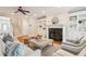 Bright living room featuring a fireplace, hardwood floors, built-in shelving, and staircase at 7 Seahorse Ct, Isle of Palms, SC 29451