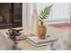 Stylized decor on a coffee table, featuring books, vases, and decorative elements next to a fireplace at 7 Seahorse Ct, Isle of Palms, SC 29451