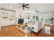 Spacious living room with hardwood floors, built-in bookshelves, a fireplace, and comfortable seating areas at 7 Seahorse Ct, Isle of Palms, SC 29451