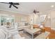 Open living room with hardwood floors, ceiling fans, neutral decor, and an adjoining dining space at 7 Seahorse Ct, Isle of Palms, SC 29451