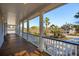 Expansive porch view showcasing elegant columns, wooden floors, and lush landscaping in the distance at 7 Seahorse Ct, Isle of Palms, SC 29451