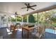 Covered porch with ceiling fans, outdoor dining and lounge furniture, and pool view at 7 Seahorse Ct, Isle of Palms, SC 29451